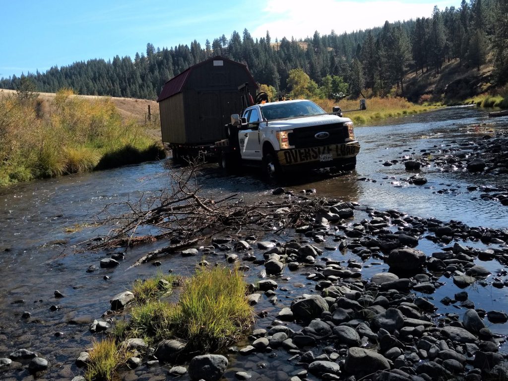 pictured truck delivery across a low portion of a river